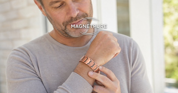 Man calmly checking the skin on his wrist while wearing a copper magnetic bracelet